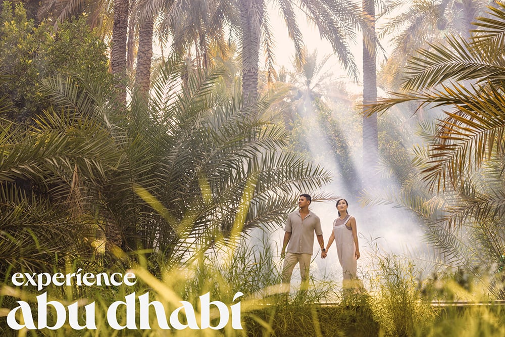 Man and woman stand in nature holding hands, for Experience Abu Dhabi campaign, shot by Tom Parker.