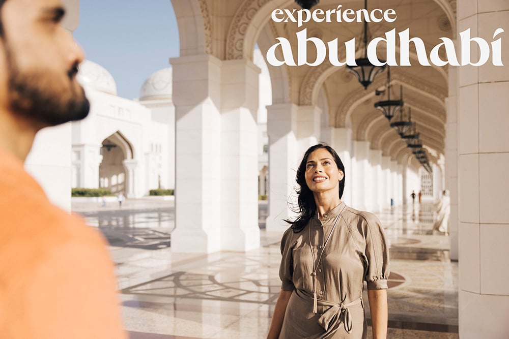 A woman takes in the architecture in a mosque for Abu Dhabi tourism campaign shot by Tom Parker.