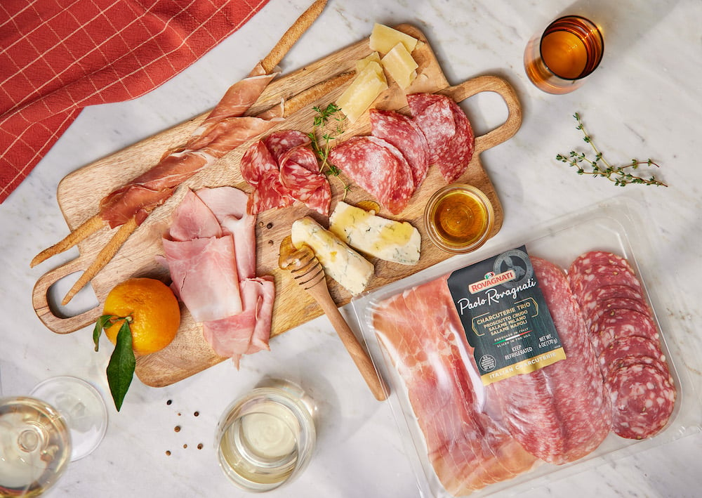 Rovagnati product photo of cured meats, breadsticks, orange, cheese, honey, and wine, by Brooklyn-based food/drink photographer Trevor Baca.