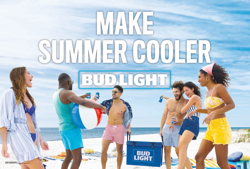 Photo with campaign name brand text of six friends on beach in swimwear with Bud Light beers, by Atlanta, Georgia-based brand narrative photographer Fernando Decillis.
