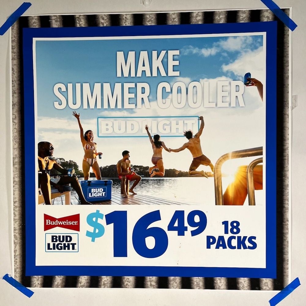 Tear sheet poster with pricing for 18 pack of Bud Light beers.