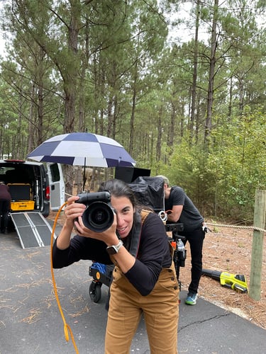 Photographer Natalia Weedy poses with her camera on set for Fayetteville, North Carolina tourism bureau.