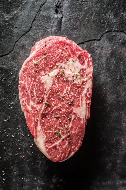 image of a seasoned steak on a granite countertop