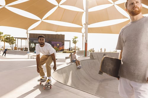 Men enjoying a skatepark in Abu Dhabi, shot by London photographer Tom Parker.