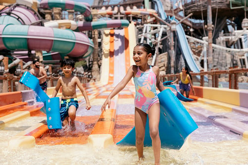 Children at a waterpark photographed by Tom Parker for Experience Abu Dhabi.