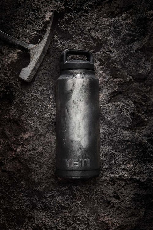 Photo by Jeff Wilson of a Yeti bottle in the dirt next to a pick axe.