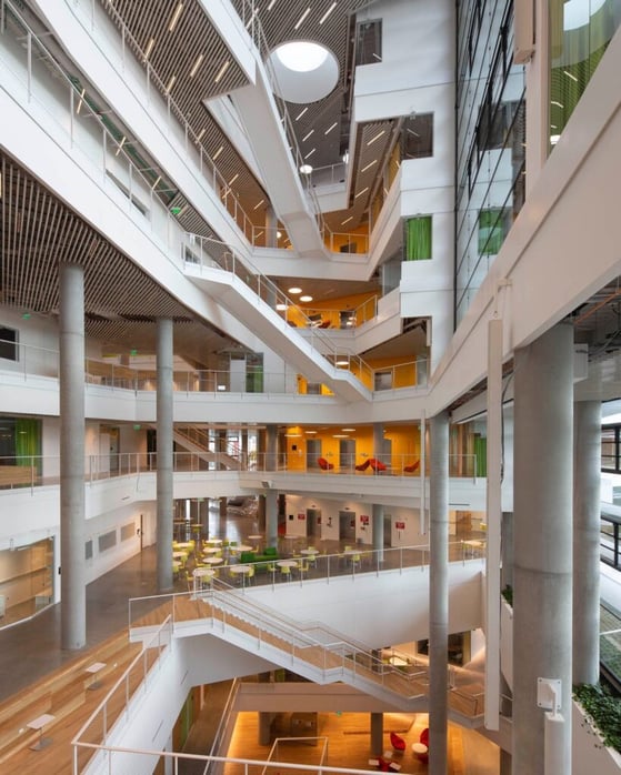 Photo by Steve Dunwell of a futuristic interior with many stairways and balconies.