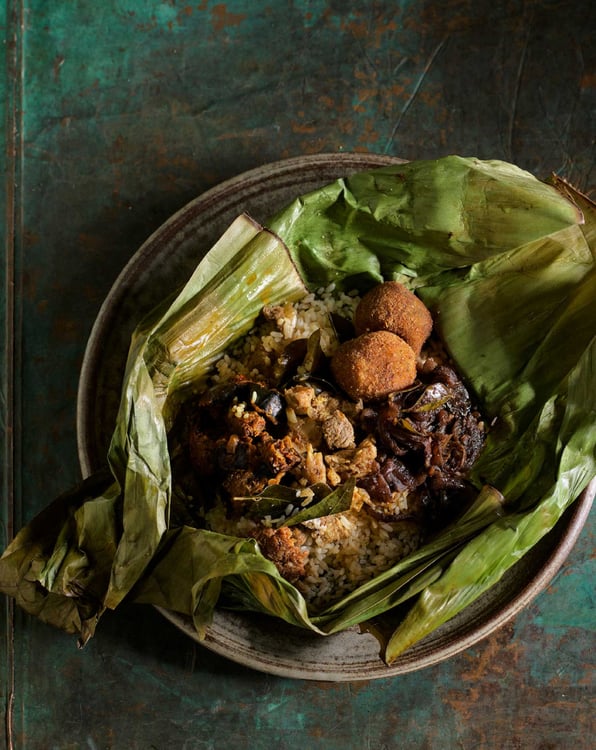 Photo by Anson Smart of a rice dish wrapped in leaves.