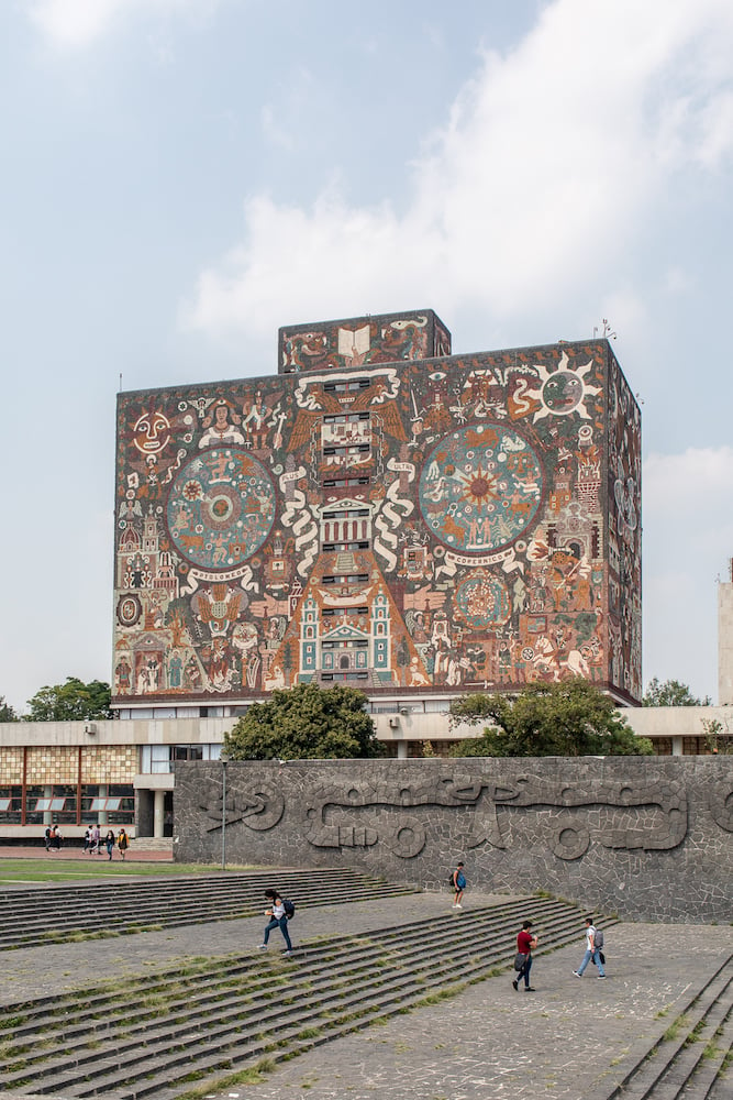 Image of traditional pale-colored art mural on building front, by Mexico City-based travel photographer Andrew Reiner. 