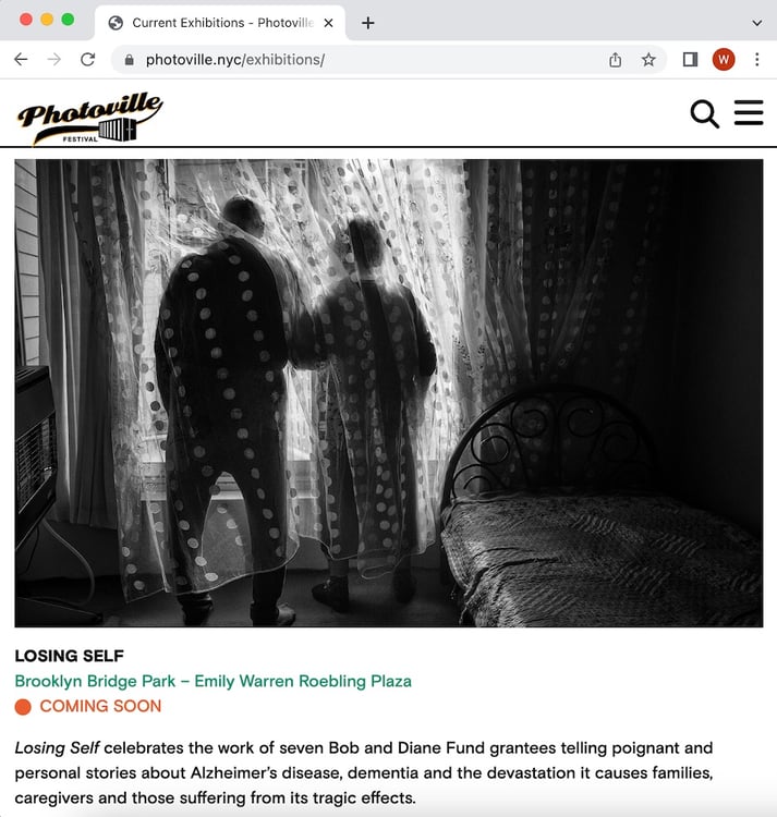 Screenshot of The Bob and Diane Fund "Losing Self" exhibition promo for Photoville 2023. The image is two figures, backs turned, standing inside a translucent curtain, looking out a window.
