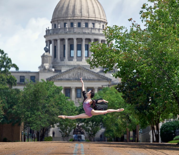 Portrait of dancer in leotard, in jump split midair, by Tuscaloosa, Alabama-based music/performing arts photographer Michael J. Moore.