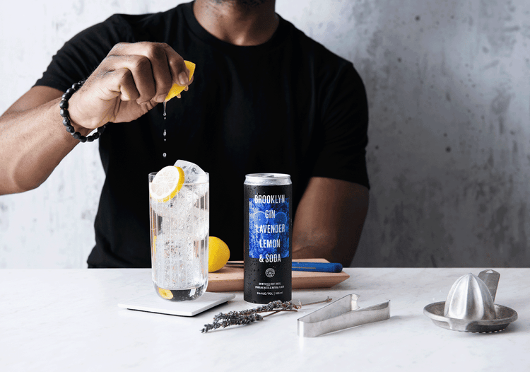 Gif by Michael Marquand of a person squeezing a lemon into an ice-filled glass next to a canned cocktail. Brooklyn Gin, canned gin, gin, alcohol, canned drinks, cocktail, drink, Michael Marquand, beverage photography, product photography, beverage photographer, product photographer