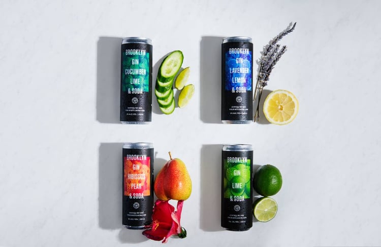 Photo by Michael Marquand of four canned cocktails each next to their main ingredient. Brooklyn Gin, canned gin, gin, alcohol, canned drinks, cocktail, drink, Michael Marquand, beverage photography, product photography, beverage photographer, product photographer