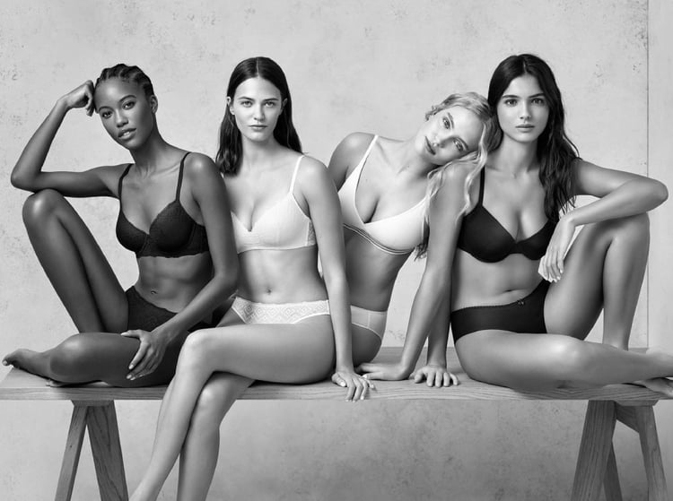 Photo in black & white by Maki Galimberti of four diverse women modeling undergarments. 