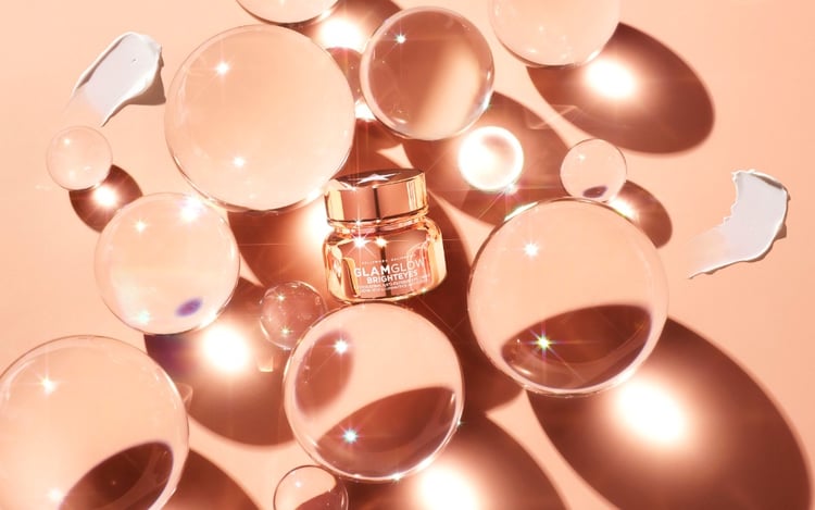 Photo by Adam and Robin Voorhes of a cosmetics jar sitting within a bunch of transluscent orbs