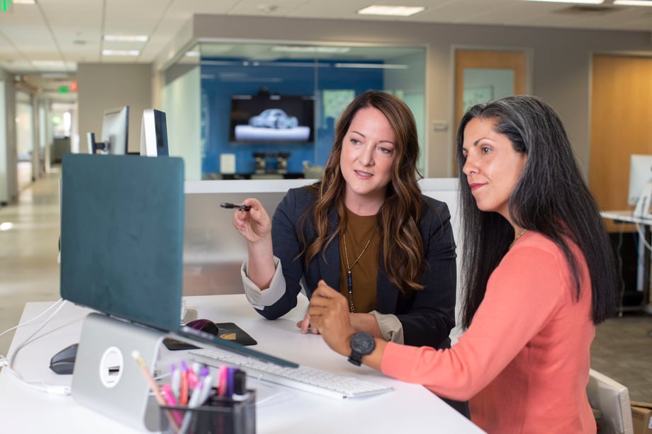 Sabrina Hill's image for LinkedIn shows two women sitting in front of a monitor at an office, having a discussion