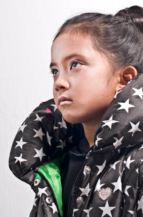 A young girl in a star clad jacket photographed by Kinzie+Riehm