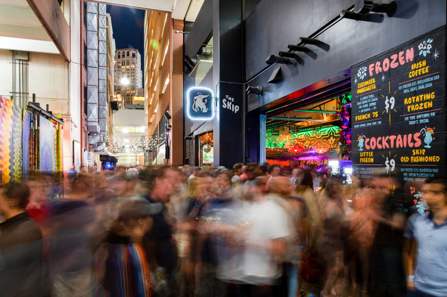 Marvin Shaouni shoots a time-lapse photo of a crowd of shoppers outside of an outdoor bar called The Skip