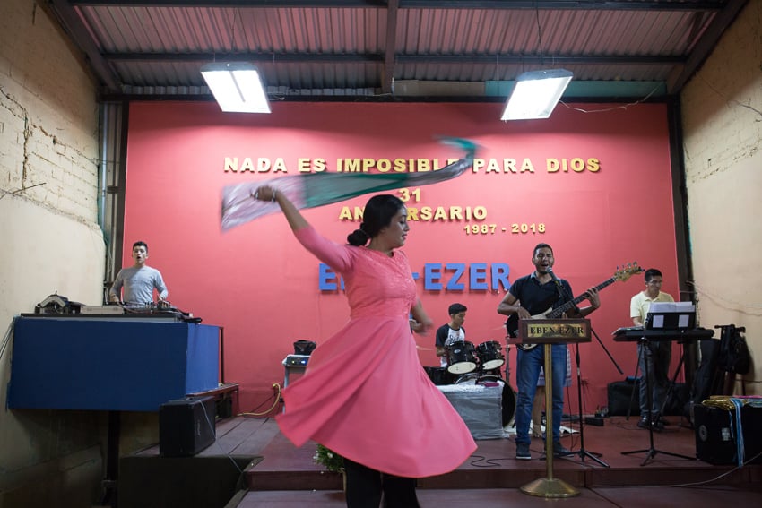 Photo of a woman dancing in front of a band published on NPR taken as part of an IWMF Adelante reporting fellowship by Alicia Vera