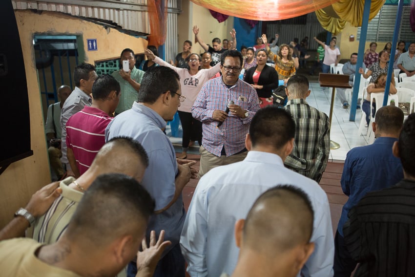 Photo of people, including ex-gang members, attending church published on NPR taken as part of an IWMF Adelante reporting fellowship by Alicia Vera