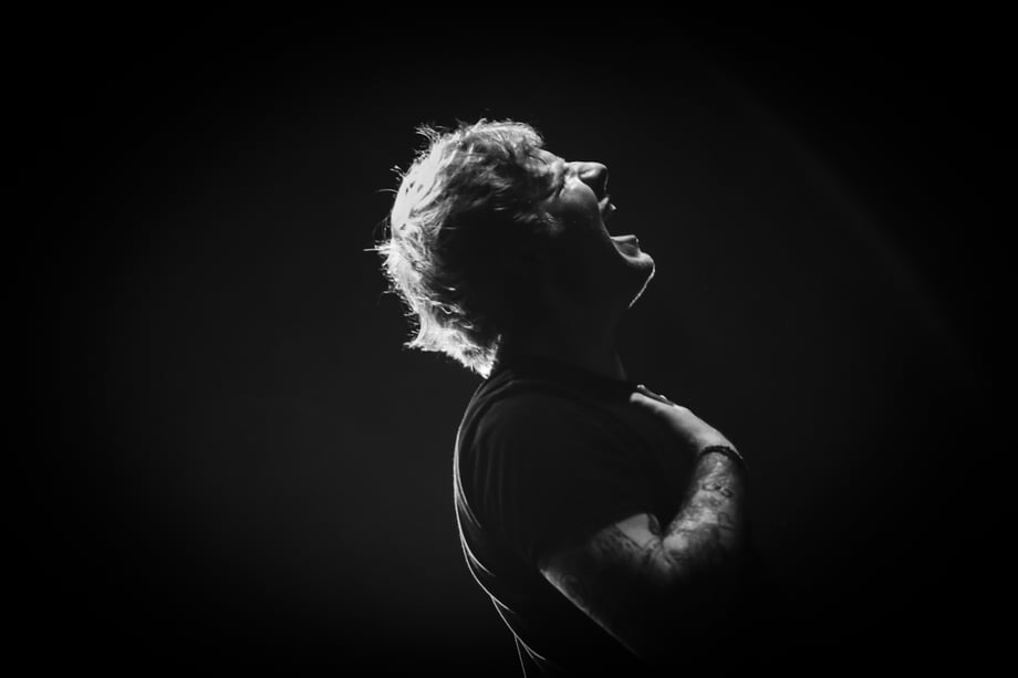 Christie Goodwin captures a photo of Ed Sheeran with his head back, singing, with a hand over his heart