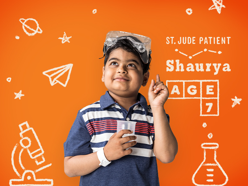 Terri Glanger shows St. Jude patient Shaurya, age 7, is wearing goggles and holding a beaker against an orange backdrop