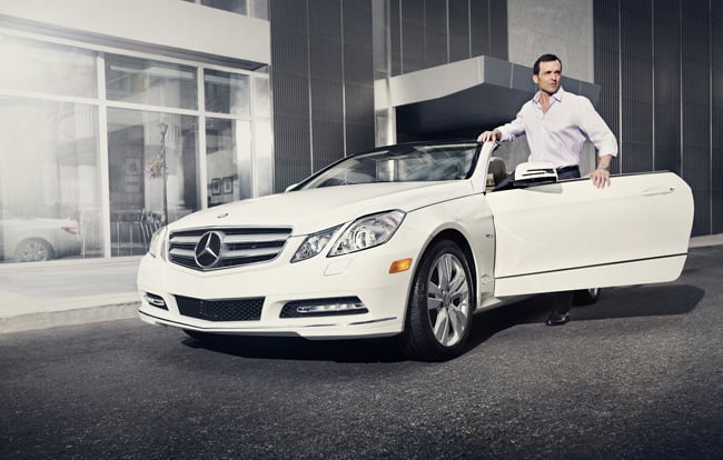 A man standing near a white Mercedes-Benz