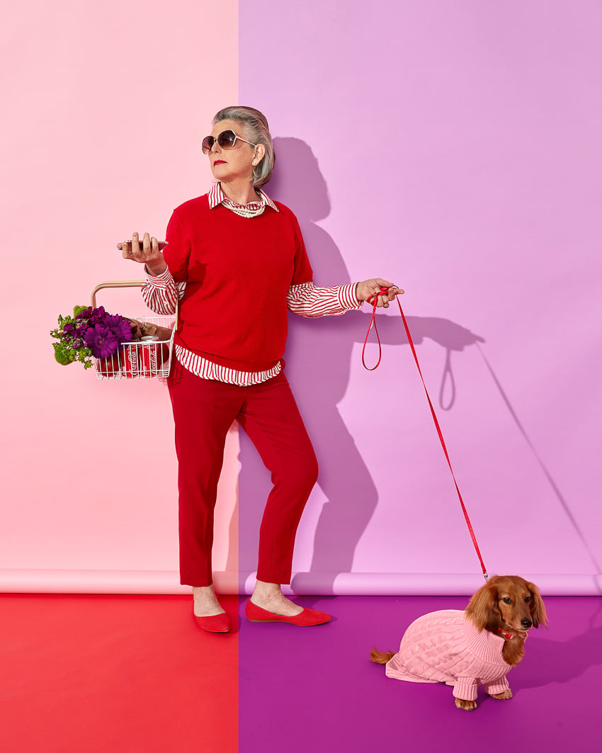 Photo of a woman with her a dog on a leash in a half red and half purple room for the Color is Everything Seattle Art Museum project.