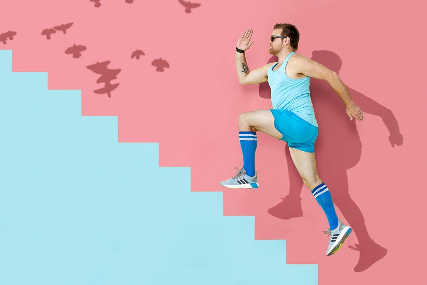 Photo of a man running up a blue staircase and a pink wall for the Color is Everything Seattle Art Museum project.