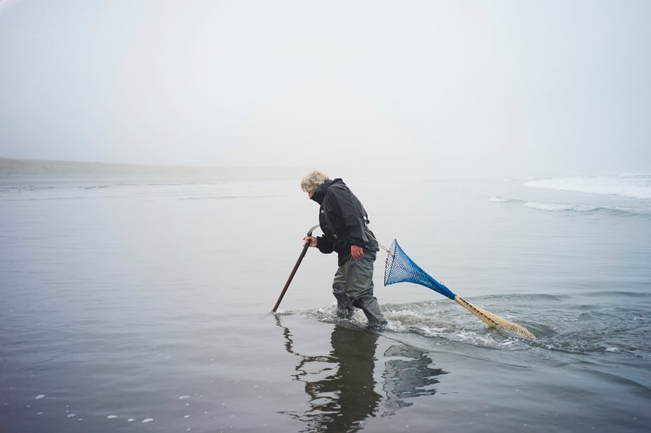 Richard Darbonne photographs Ron Neva trudging through the water hunting for razor clams for 1859 magazine
