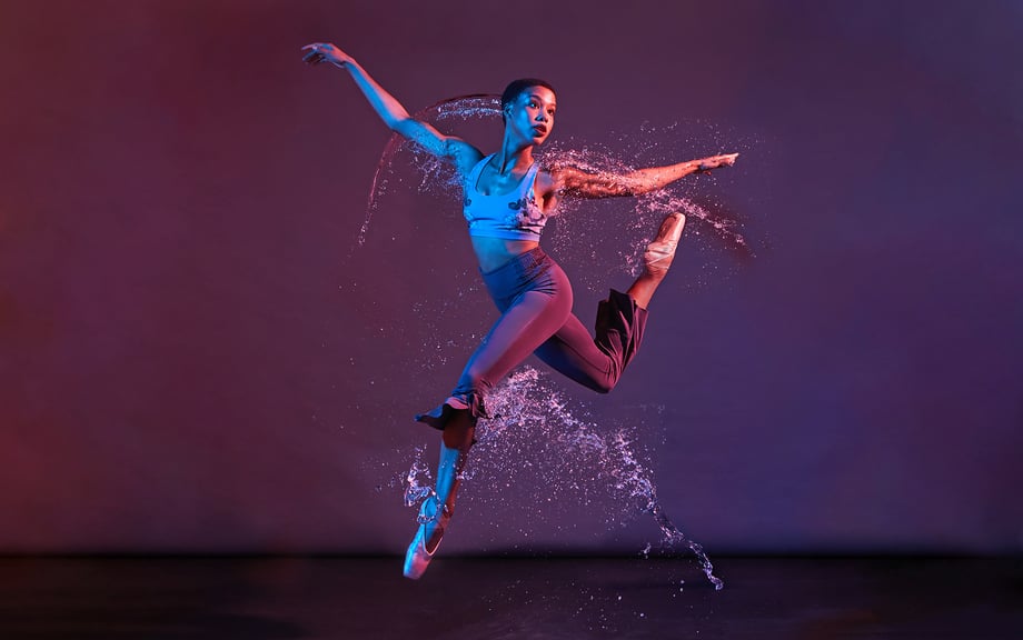 Female ballet dancer leaps into delicate arcs of water