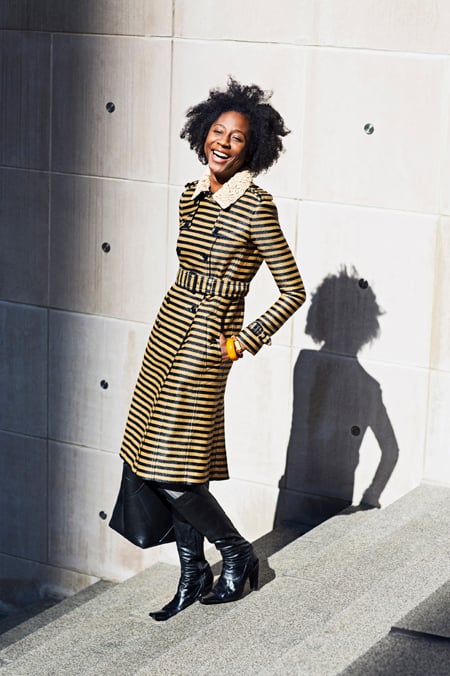 A smiling woman in a striking striped Burberry trench coat
