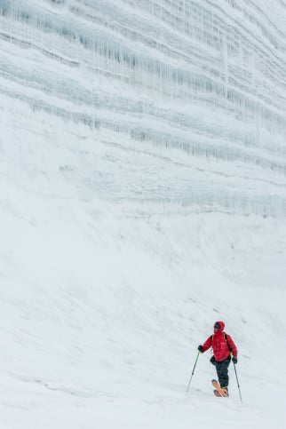 Tony Hoare skis next to a nunatak wall during a spring storm.