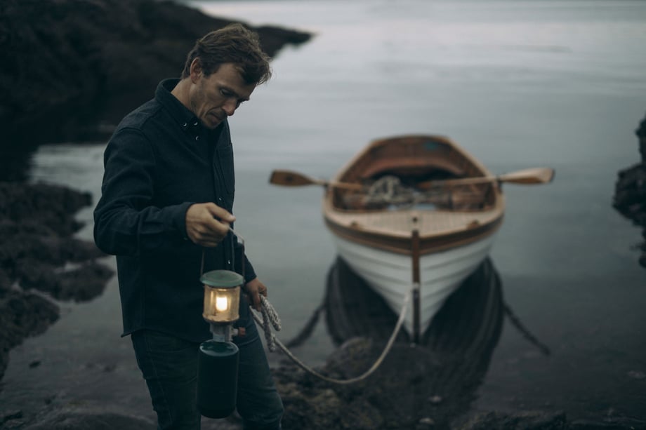 Mackenzie Duncan's favorite shot from this series shows a man holding a lantern while holding a rope attached to a rowboat