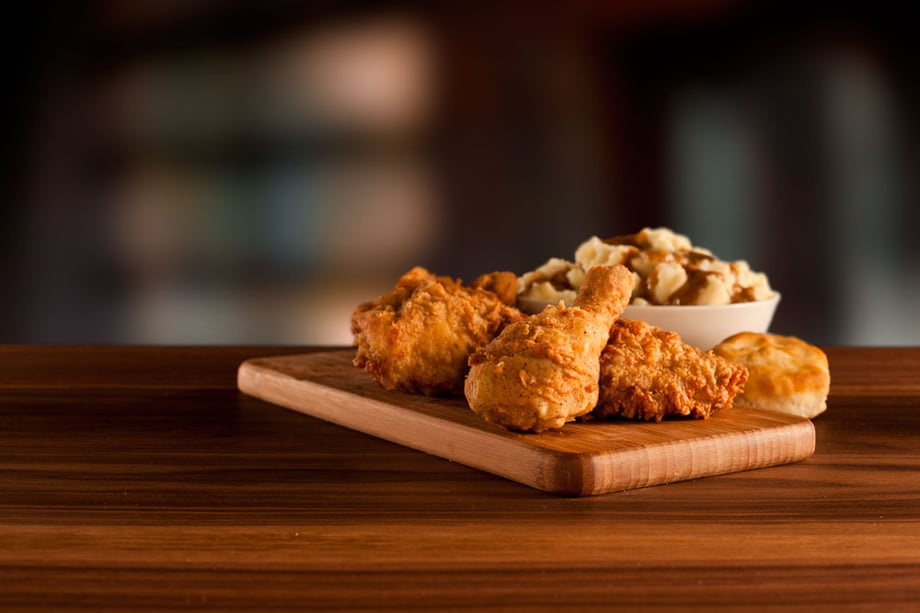 Crispy KFC Drumsticks on a wooden board and mashed potatoes on the side, Yum!