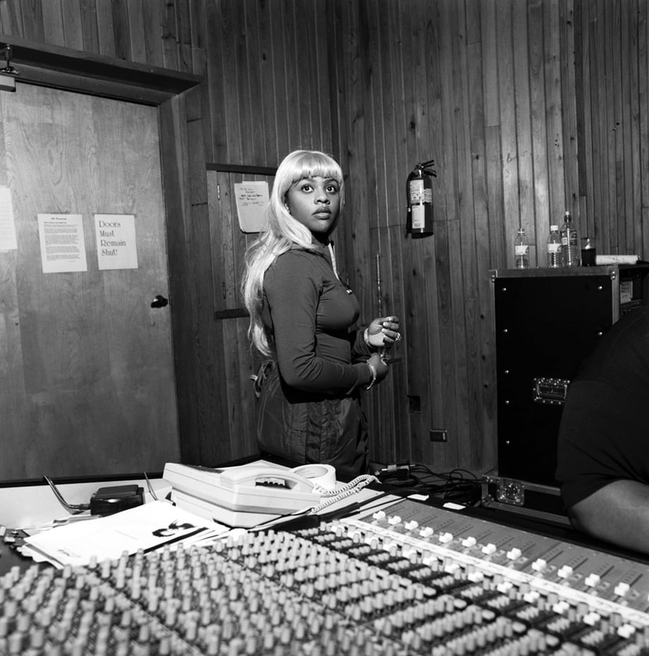 Photo of a young Lil' Kim in the studio.