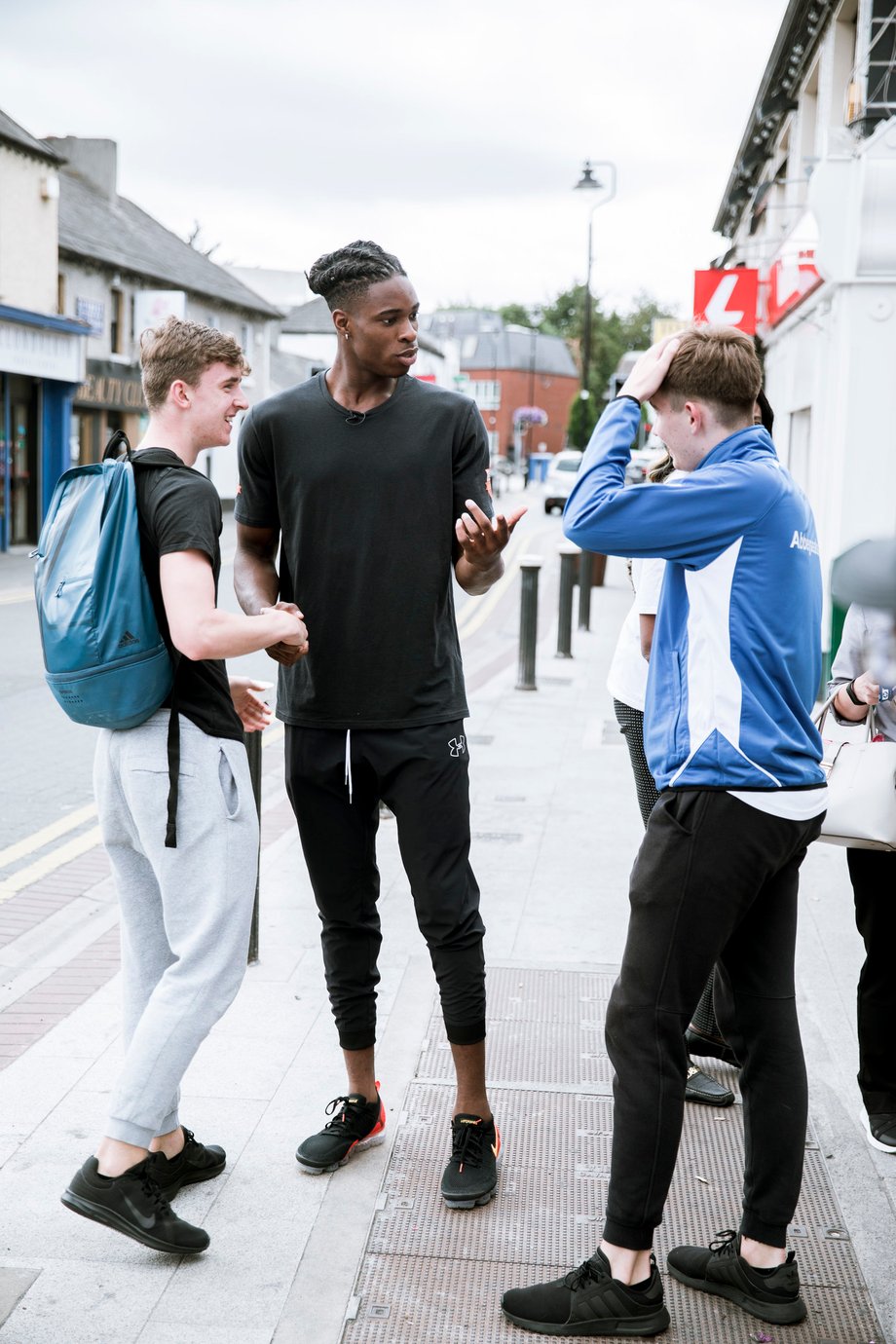 Johnnie Izquierdo catches teens wanting to talk to Aidan as they walk through the streets