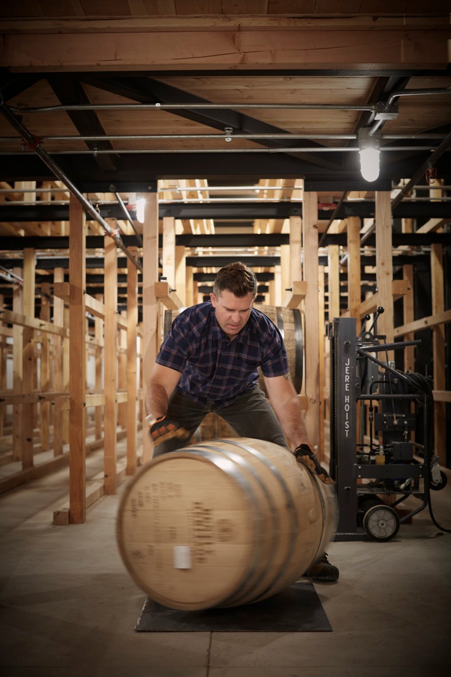 Jody Horton photographs team member John Crumbley spinning a barrel at Bently Heritage Estate Distillery.