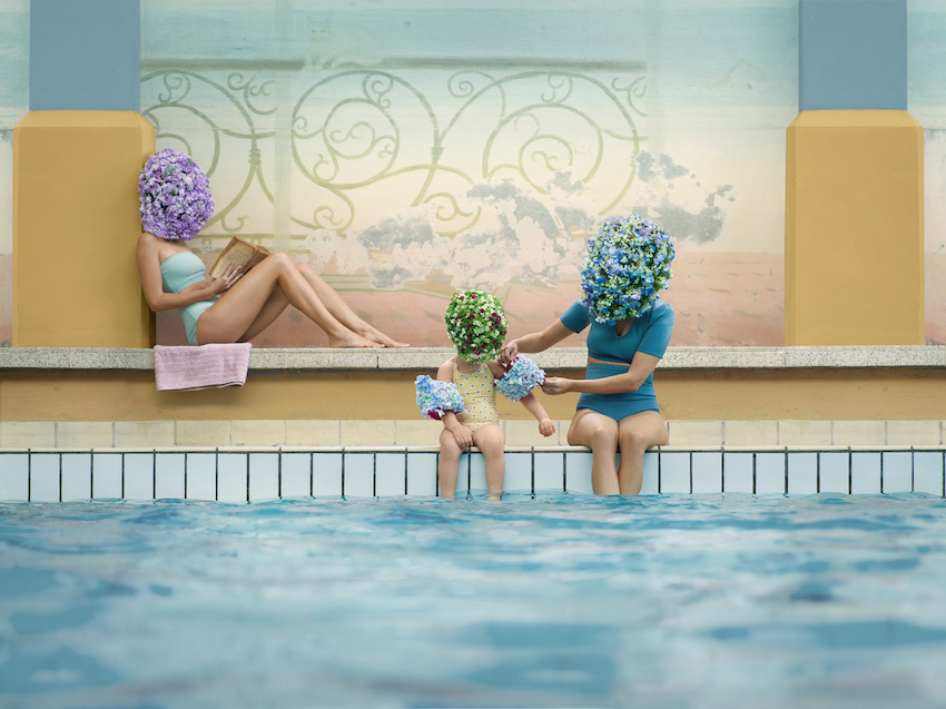 Three Flowerheads sitting by indoor pool.