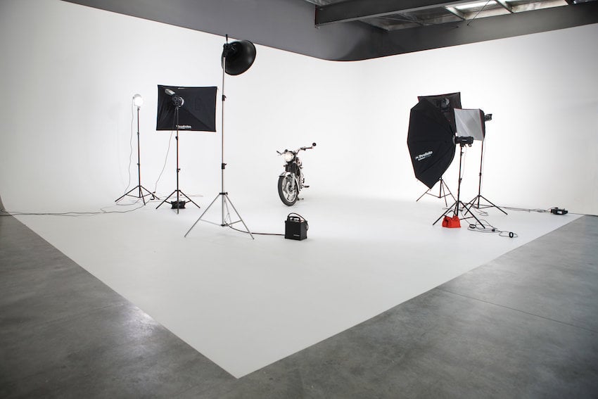 Motorcycle photoshoot set-up in large, open photography studio.