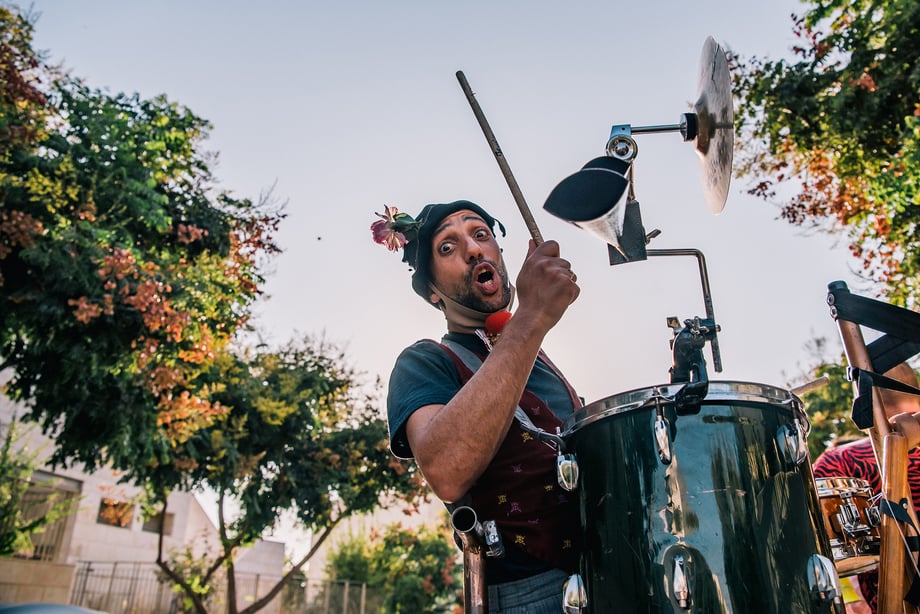 Arik Shraga photographs a very silly looking drummer from DAVAI Theater Group as he makes music with his all in one contraption