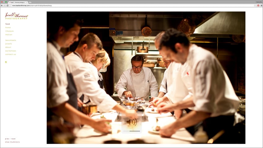 Screencap of Beall + Thomas new website featuring a photograph of chef's working at a long table.