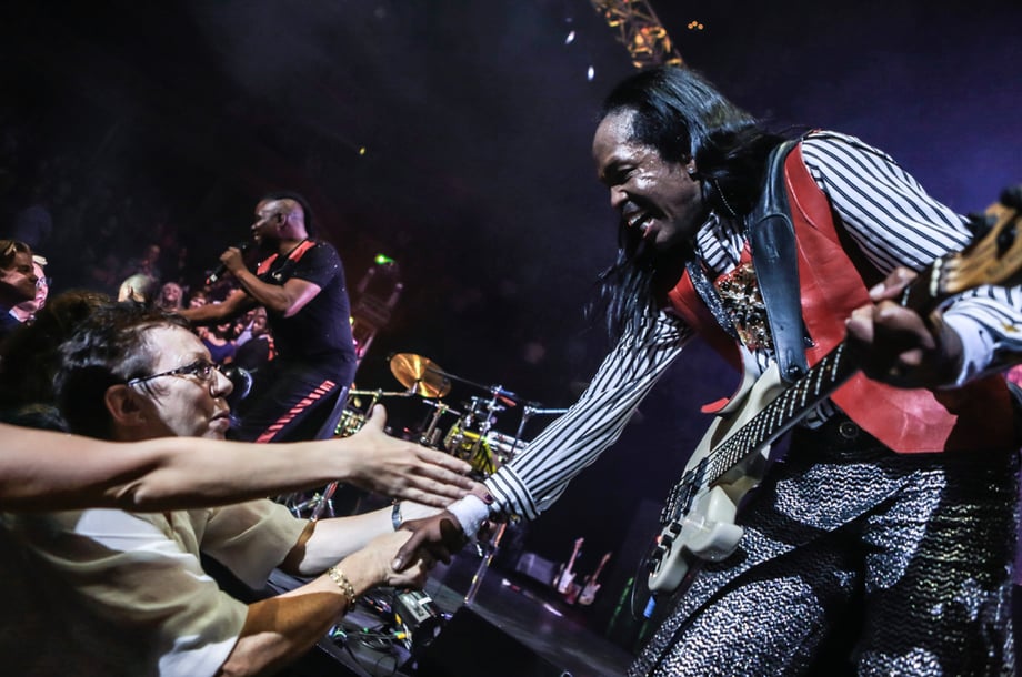 Christie's shot of Verdine White shaking fans' hands at an Earth, Wind & Fire show in 2013