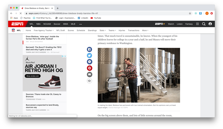 Chona Kasinger shows Drew Bledsoe in front of a row of stainless steel wine tanks on ESPN's website