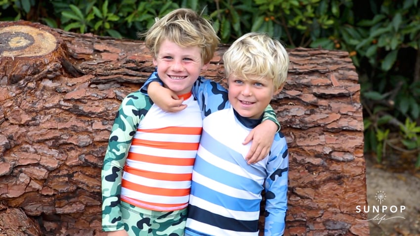 Photo of two young boys wearing SunPopLife swimsuits shot by photographer Caroline Woodham.