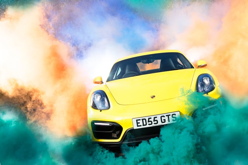 Porsche Carrera GTS with clouds of colored smoke by Darren Woolway