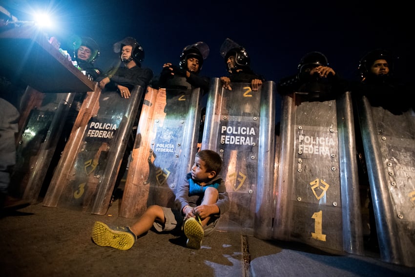 Sean Rayford's photo of a small child sitting in front of a line of guards carrying shields
