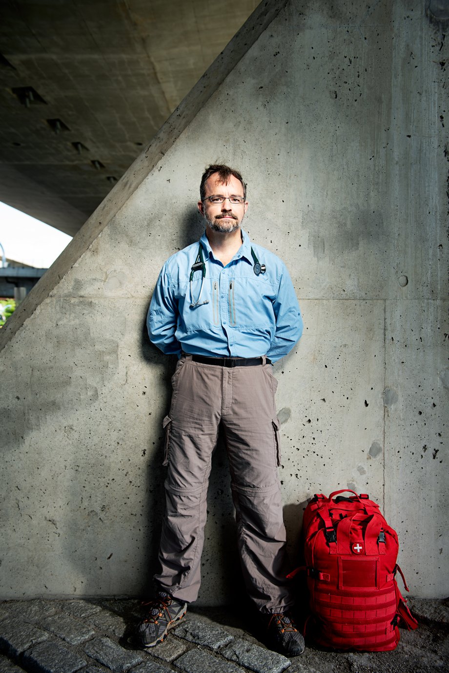 Webb Chappell's portrait of Dr. Harris under a bridge with his bag and a stethoscope