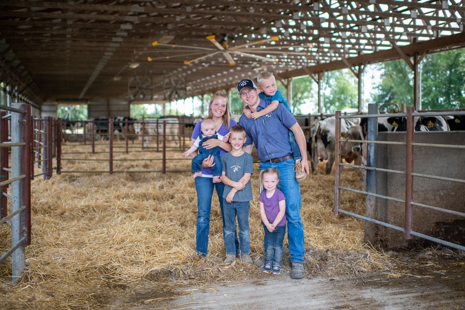 Chad Holder's photo of a young couple and their three small children standing in an open pen with cows behind them