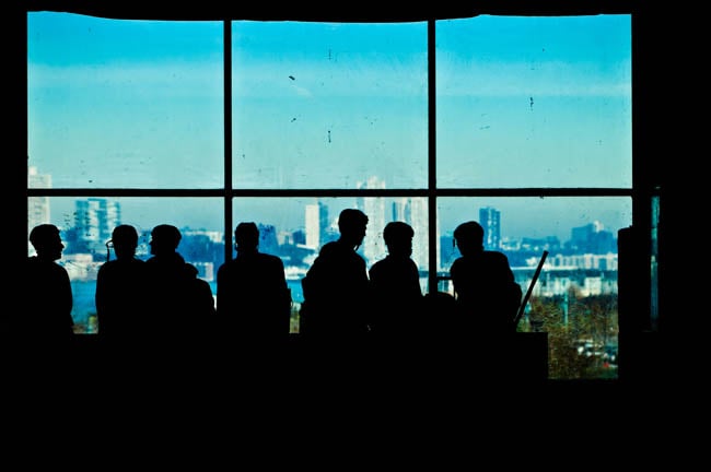 Figures in front of a large window shot by Dallas-based portrait photographer Trey Hill